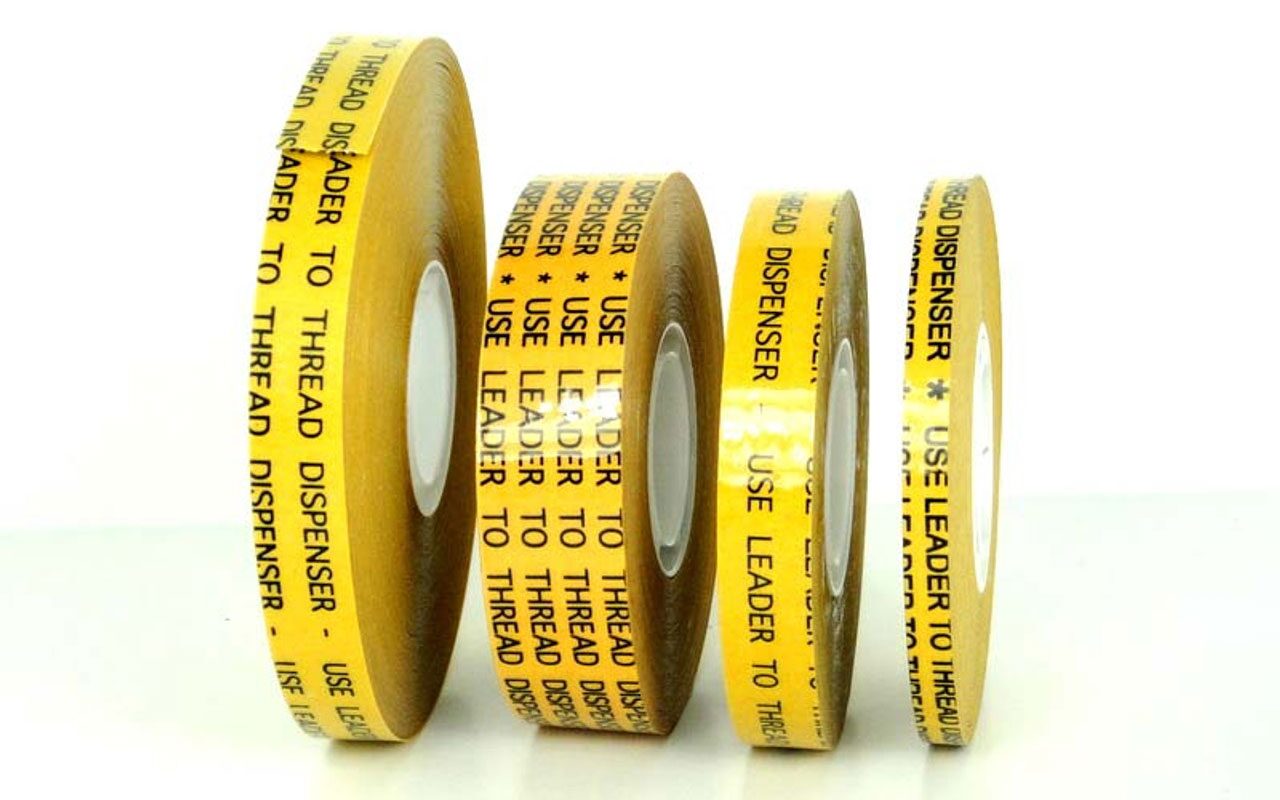 Four rolls of yellow thread dispenser tape.
