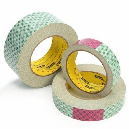 Colorful rolls of adhesive tape stacked together.