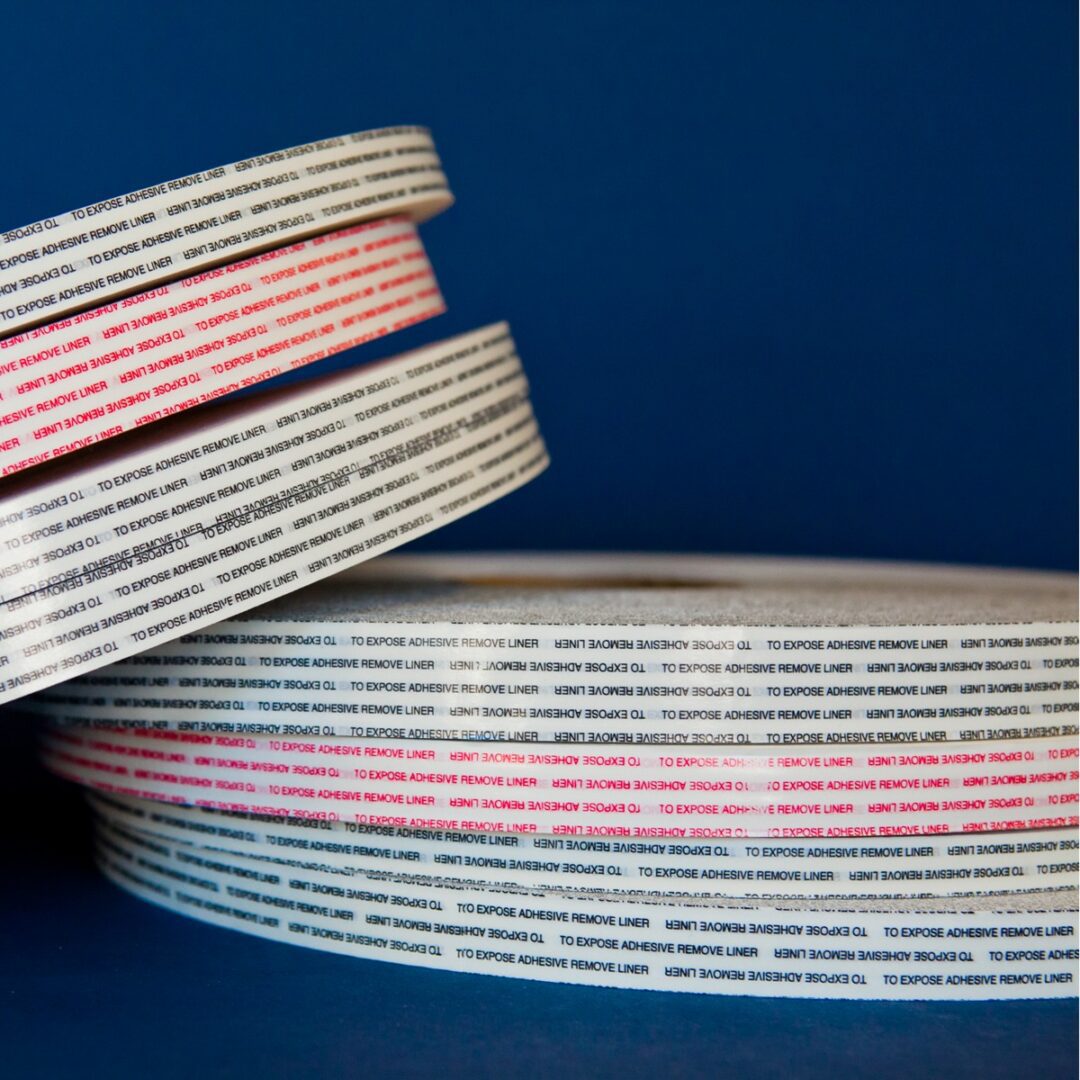 Stacked rolls of black text tape.
