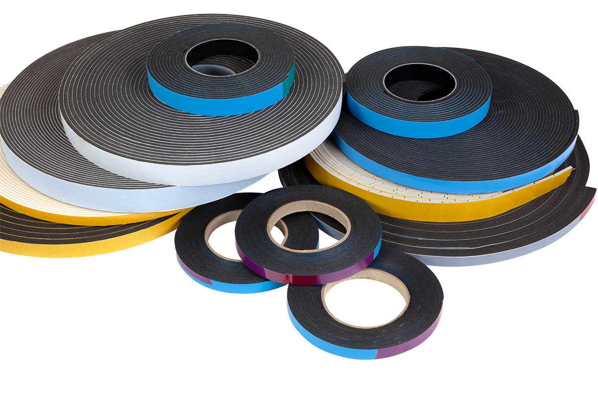 Rolls of colorful adhesive tape stacked together.