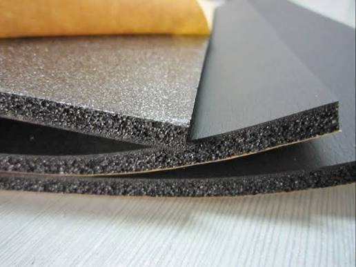 Foam sheets stacked on a wooden surface.