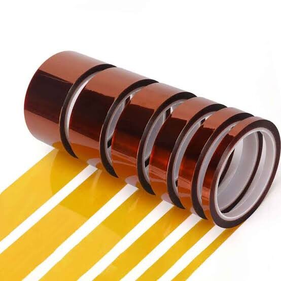 Five rolls of brown adhesive tape unrolling.
