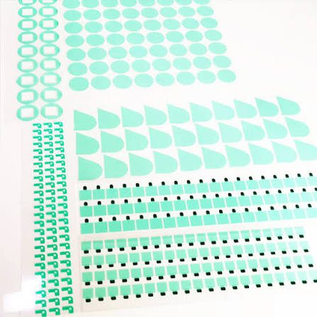 Green geometric stickers on white background.