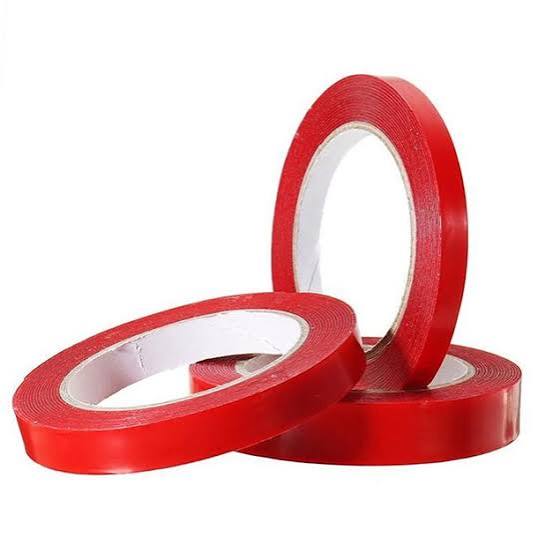 Three rolls of red adhesive tape.