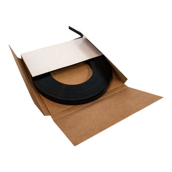 Black plastic band in open cardboard box.