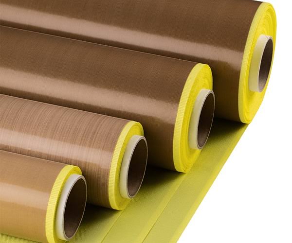 Four rolls of brown and yellow fabric.