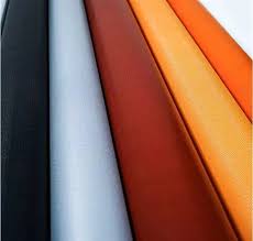 Colorful fabric rolls in diagonal arrangement.