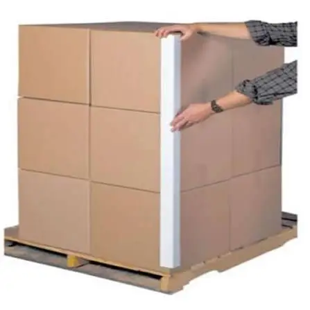 Man pushing a stack of cardboard boxes on a pallet, with a white background