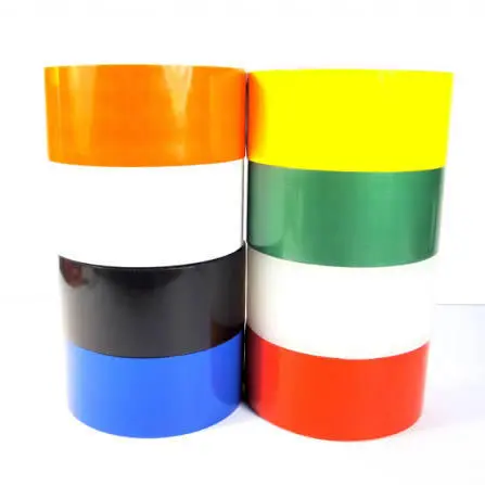 Stack of three colorful plastic containers on a white background