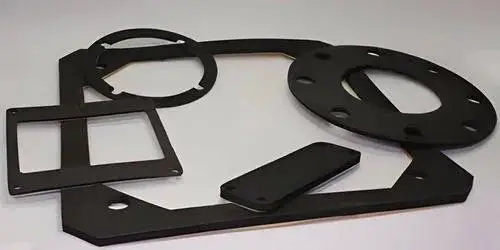 Set of four black metal gaskets on a white surface, which are part of a custom-made, custom-built