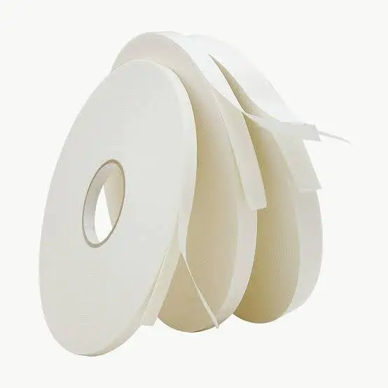 Roll of white double-sided foam tape on a white background
